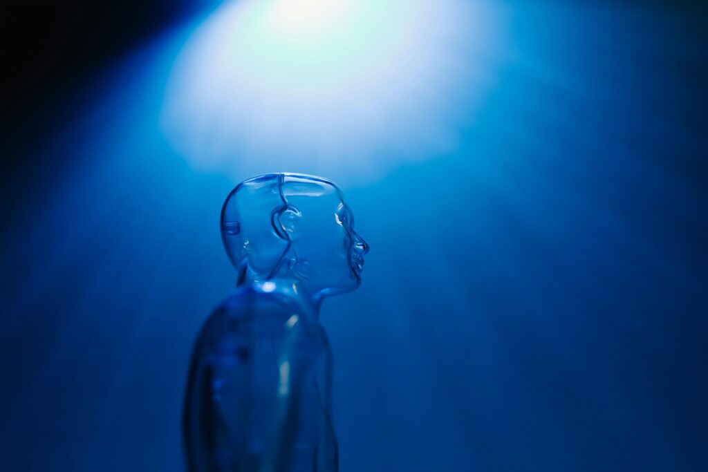 pexels-photo-8386365-8386365 Transparent robotic figure illuminated by blue light, symbolizing AI and futuristic technology.